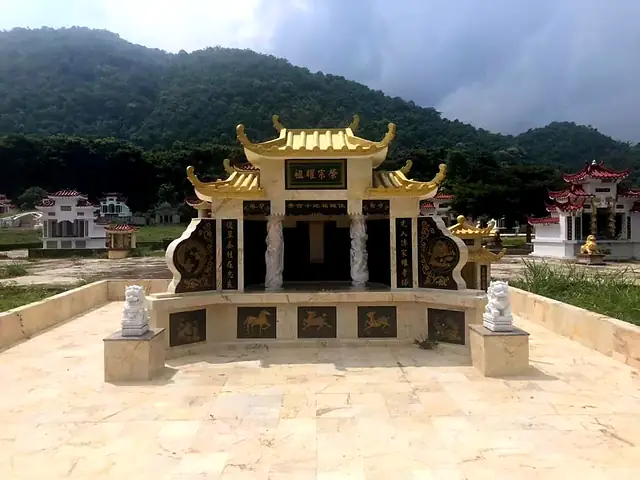 Chinese tomb with golden roof and a pair of stone lions