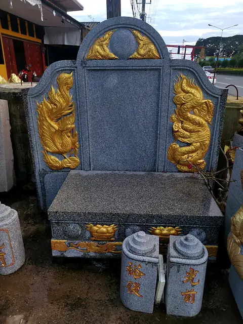 Granite headstone carved with gold dragons