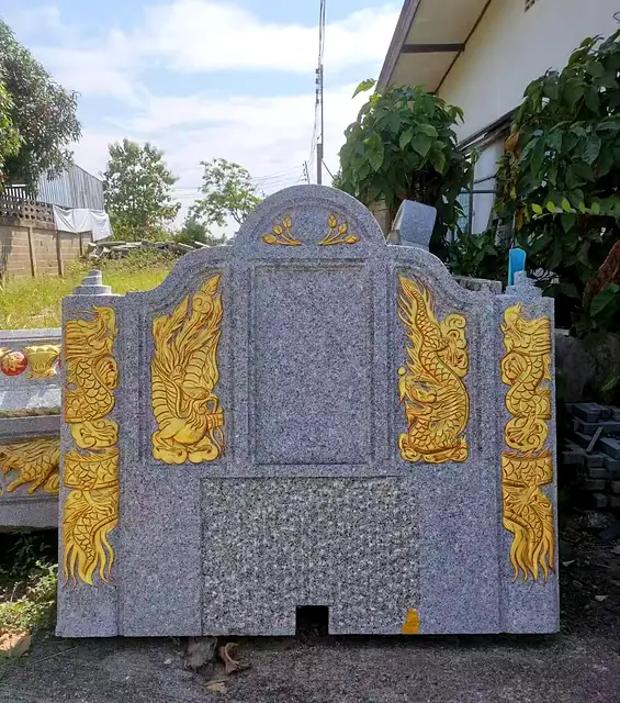Granite headstone with gold carving on both sides