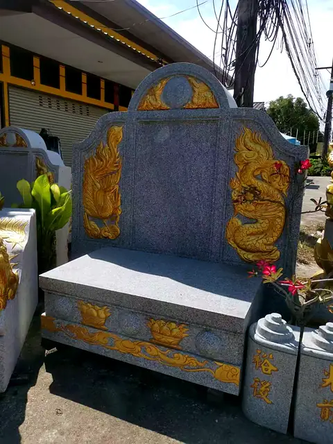 Granite headstone with gold dragons and offering altar
