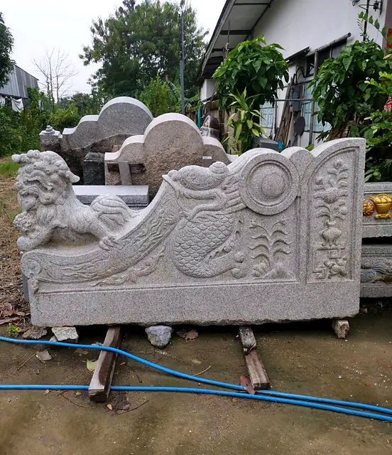 Granite side wall with carved lion before painting